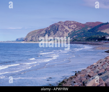 Boulder Rip-Rap Küstenschutz, mit Penmaenmawr, darüber hinaus, in der Nähe von Conwy, Gwynedd, Nordwales, UK. Stockfoto