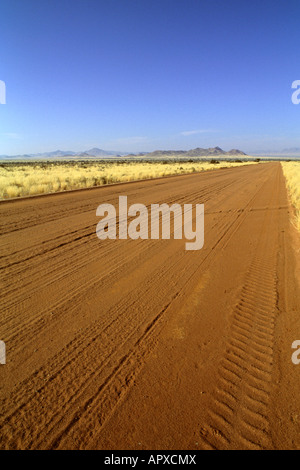 Eine lange, flache und gerade Sand Straße erstreckt sich bis zum Horizont in der Nähe von Sossusvlei Stockfoto