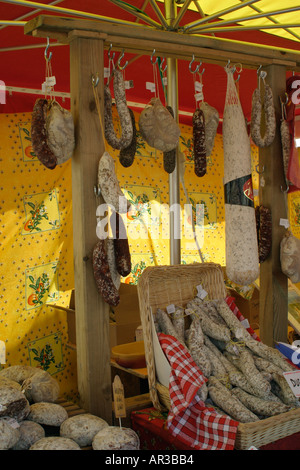 Auswahl an Fleisch hängen und Würstchen am Marktstand in Weidenkörbe Stockfoto