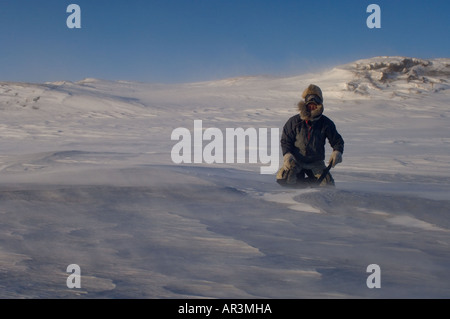 Inupiat Führer Jack Kayotuk schneidet ein Eisblock während Sturm entlang der arktischen Küste Ost Arctic National Wildlife Refuge-AK Stockfoto