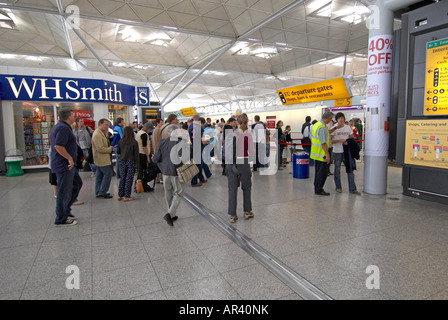 Passagiere im Flughafen Stansted zu Fuß in Richtung Sicherheit Stockfoto