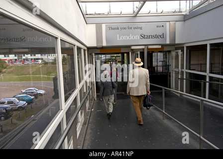 Passagiere, die hinunter Korridor aus Stansted - älteres Ehepaar plus die 3. Dame auf der linken Seite des Gent mit Hut sind Herr. Stockfoto