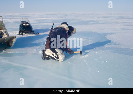 Inupiat-Anleitung, die Jack Kayotuk ein Eisblock schneidet schmelzen für Trinkwasser entlang Alaska Arctic National Wildlife Refuge Stockfoto