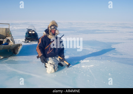 Inupiat-Anleitung, die Jack Kayotuk ein Eisblock schneidet schmelzen für Trinkwasser entlang Alaska Arctic National Wildlife Refuge Stockfoto