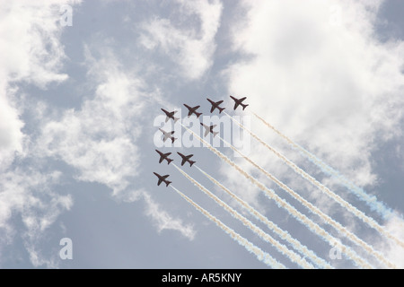 Die Welt berühmten Royal Air Force Red Arrows an einem teilweise bewölkten Himmel über Bournemouth, Dorset während der jährlichen Sommer-Karneval. Stockfoto