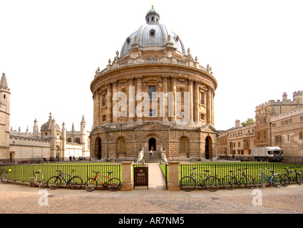 Fahrräder an den Zaun der Gebäude, die Häuser der Bodleian Library an der University of Oxford Radcliffe Kamera gekettet. Stockfoto