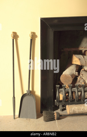 Holzofen-Protokolle Rost & Werkzeuge inmitten Abend Sonnenlicht Stockfoto