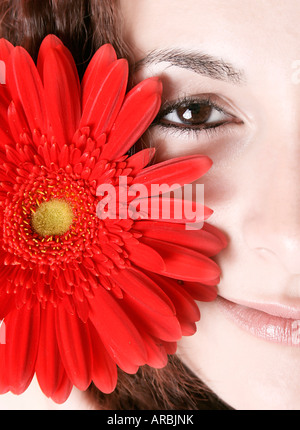 Makro-Bild von einem Mädchen Gesicht mit einer roten Blume Stockfoto