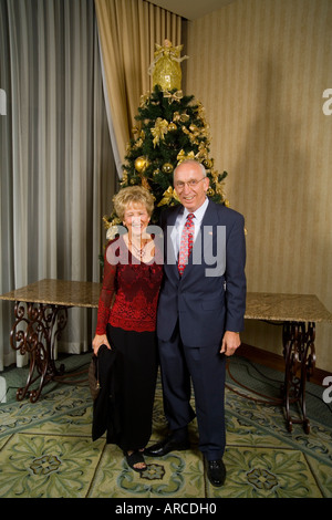 Einer mittleren gealterten paar Pose für eine formale Bild vor einem Weihnachtsbaum Stockfoto
