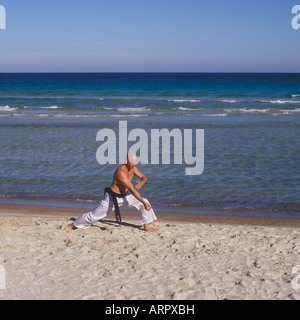 Professional-Tai-Chi und Kong Fu Lehrer Unternehmen Training am Strand in Mallorca, Balearen, Spanien. Stockfoto