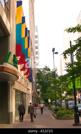 Geschäftsleute in Anzügen, die an einem sonnigen Tag durch die Innenstadt von Charlotte, North Carolina, USA, spazieren. Stockfoto