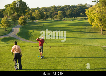 ILLINOIS Aurora erwachsenen männlichen Golfer auf Phillips Park Golfplatz Mann geschwungen Golfclub am Abschlag Blick auf fairway Stockfoto