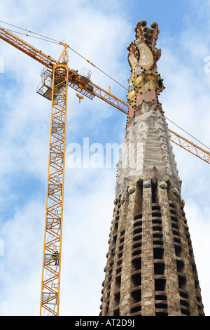 Bau Arbeiter Heads-up seine Kran über Antoni Gaudi s Temple Expiatori De La Sagrada Familia in Barcelona Spanien Stockfoto