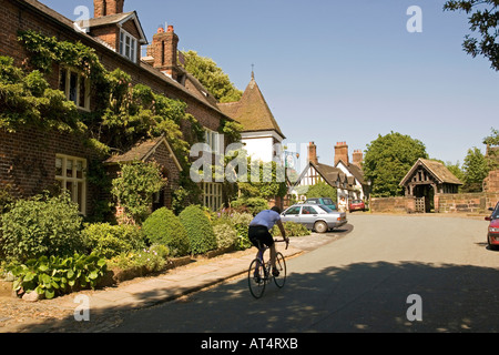 Cheshire Arley Great Budworth Radfahrer auf der Straße durch den Ort, vorbei George Drachen öffentlichen Haus Stockfoto