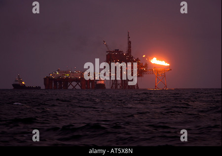 massive Rig Komplex mit 2 Lieferung Boote in der Nacht in Nordsee Stockfoto