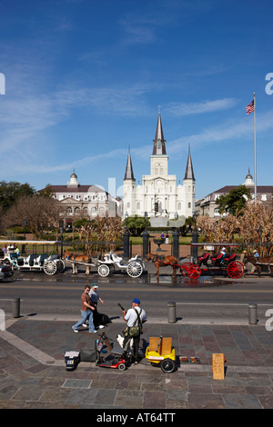 Ein Straßenmusiker spielt Musik in der Decatur Street vor der St. Louis Cathedral aus dem 18. Jahrhundert. New Orleans, Louisiana, USA. Stockfoto