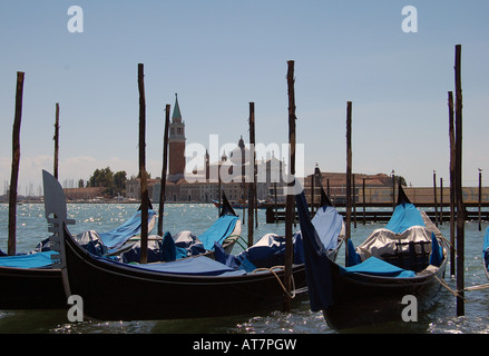 Blick über Markusplatz Becken auf drei festgemachten Gondeln mit der Insel San Giorgio Maggiore im Hintergrund. Stockfoto