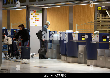 Frau Passagiere mit einem Gewicht von ihr aufgegebenes Gepäck am check-in-Schaltern auf Tenerife Sur TFS Reina Sofia Südflughafen Teneriffa Kanarische Stockfoto