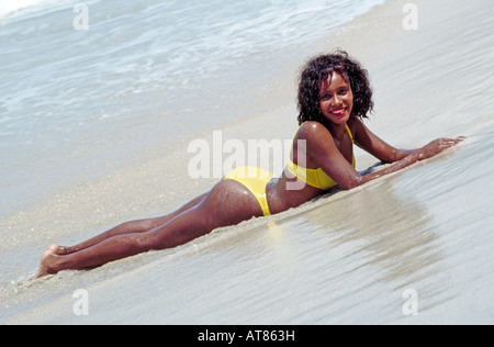 Junge Frau am tropischen Strand liegen Stockfoto