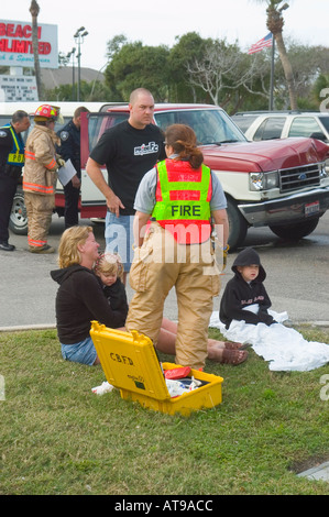 Feuerwehr Polizei und medizinisches Personal unterstützen Verletzte bei Autounfall Stockfoto