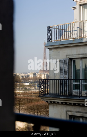 Eiffelturm gesehen aus einem Hotelfenster durch Dächer und Balkon. Eiffelturm Paris auf dem Dach Stockfoto