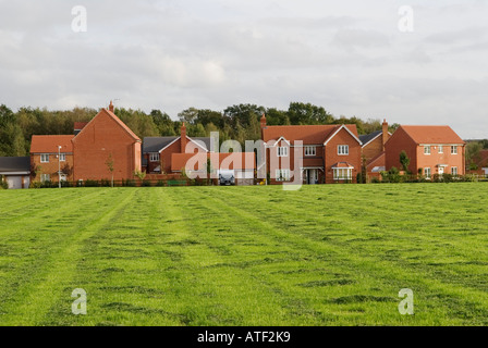 Neubau Wohnsiedlungen ländliche Entwicklung auf der Grünfläche Calvert nahe dem Kirchturm Claydon Buckinghamshire Bucks England 2006 2000er Jahre HOMER SYKES Stockfoto