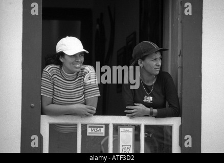 Lächelnde junge Frauen am Fenster einen Souvenir-Shop Paraty Rio de Janeiro Brasilien Brasil Süden Lateinamerikas Stockfoto