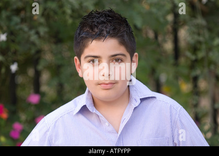 13 Jahre alte arabische Teenager tragen blaues Hemd in die Kamera schaut Stockfoto