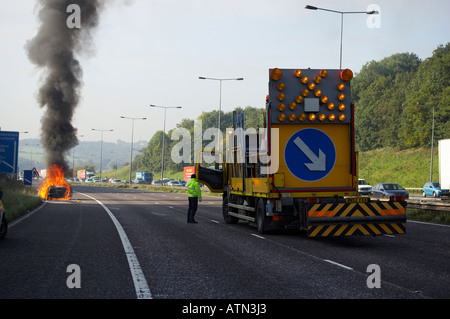 NOTFALL-DIENSTE SCHLIEßEN FAHRSPUREN IN SZENE DER BRENNENDE AUTO AUF M62 AUTOBAHN HARTE SCHULTER Stockfoto