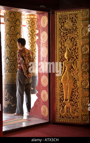 Verzierte Tür und Besucher am Wat Mai Suwannaphumaham Luang Prabang Laos Stockfoto