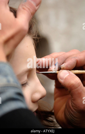 Gesicht Maler Aufdrängend ihr Handwerk an die Teilnehmer der Karneval von Venedig in Venedig Italien 2008 Stockfoto