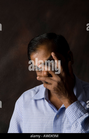 Indischer Mann versteckt Gesicht Stockfoto