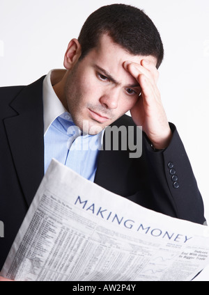 Geschäftsmann, die finanzielle Seite der Zeitung, mit der Hand auf der Stirn lesen Stockfoto