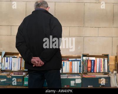 Mann sucht bei gebrauchte Bücher auf einem Marktstand - von hinten-Boxen Stockfoto