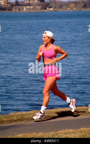 Erwachsene Frau 26 Jahre Joggen anhören von Musik rund um Lake Calhoun. Minneapolis Minnesota USA Stockfoto