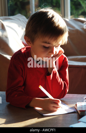 kleiner Junge seine Hausaufgaben Stockfoto