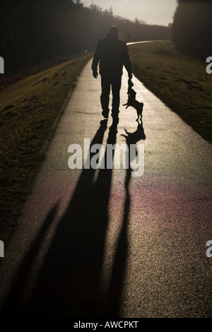 Ein Mann geht mit seinem Hund Stockfoto