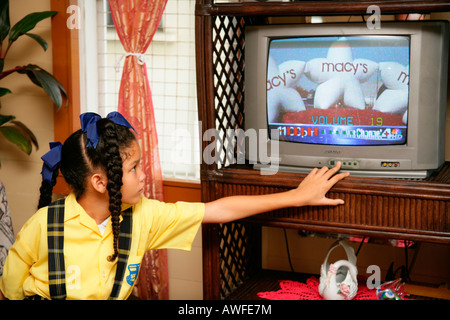 Mädchen tragen Schuluniform watching TV, Georgetown, Guyana, Südamerika Stockfoto