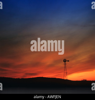 Wind-Pumpe Silhouette gegen bunte Nachthimmel Stockfoto
