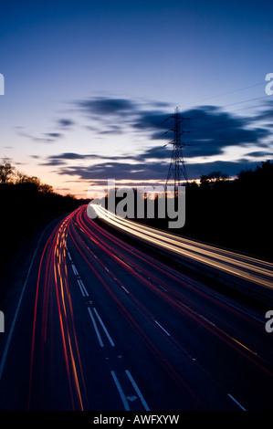 Verkehr-Trails auf zweispurigen A3 in der Nähe von Guildford bei Sonnenuntergang Surrey England UK Stockfoto