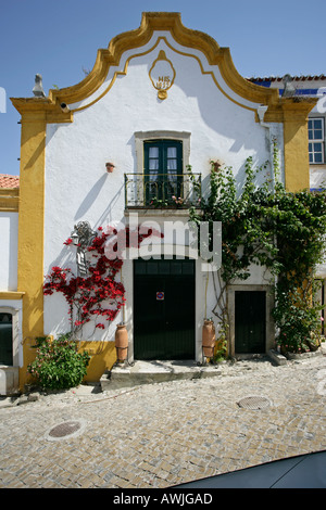 Eines der vielen bunten Gebäude innerhalb des ummauerten Zitadelle Dorfes Obidos, Portugal Stockfoto