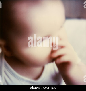 Baby saugen Daumen, Nahaufnahme, erhöhte Ansicht, verwischt. Stockfoto