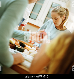 Junge Menschen, die Zubereitung von Speisen Tisch in der Küche Stockfoto