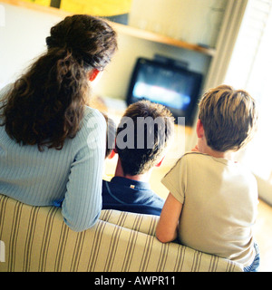 Familie sitzt auf dem Sofa vor dem Fernseher, Rückansicht Stockfoto