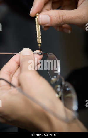 Nahaufnahme von Händen Brille reparieren Stockfoto