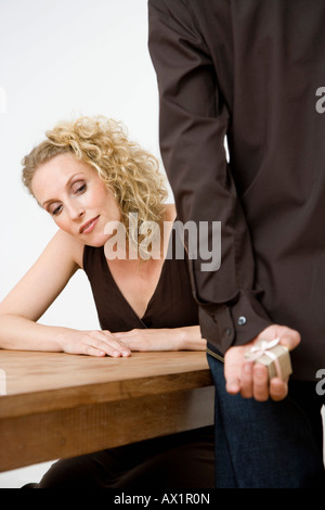 Eine Frau, die derzeit in die Hände des Mannes spähen Stockfoto