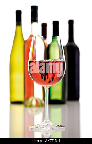 Glas Rotwein, im Hintergrund Wein Flaschen, Nahaufnahme Stockfoto