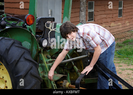 Stock Foto eines Teenagers, die Arbeit an einem Traktor Stockfoto