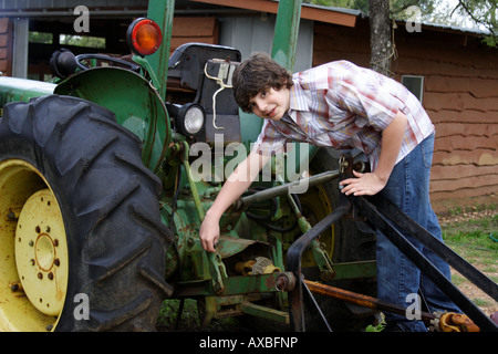 Stock Foto eines Teenagers, die Arbeit an einem Traktor Stockfoto