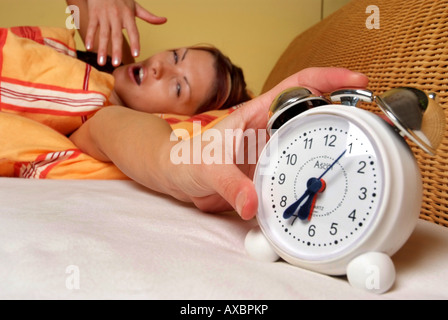 Frau erwacht mit Alarmglocke Stockfoto